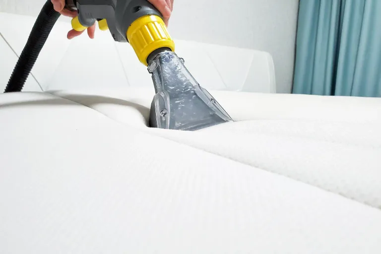 Bocal de extratora higienizando colchão branco contra ácaros